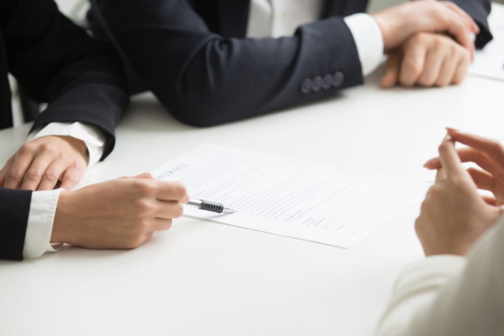 negotiations about contract terms concept hand pointing document closeup 1024x683 1